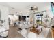 Open concept living room with kitchen view, modern furniture, wood floors, and plenty of natural light at 903 Sydney St, Davenport, FL 33837