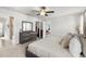 Bedroom featuring walk-in closet, dresser, ceiling fan and doorway leading into bathroom at 903 Sydney St, Davenport, FL 33837