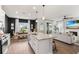 Open-concept living space featuring a kitchen island, dining area, and a cozy living room with a fireplace at 903 Sydney St, Davenport, FL 33837