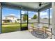 View of the well-maintained backyard from the screened patio with cozy outdoor furniture at 903 Sydney St, Davenport, FL 33837