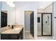 Granite vanity with dark cabinetry and modern glass shower featuring beautiful tile at 9330 Meadow Hunt Way, Winter Garden, FL 34787