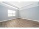 Bright and spacious bedroom features laminate flooring, a large window, and neutral paint at 9330 Meadow Hunt Way, Winter Garden, FL 34787
