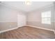 Neutral bedroom with wood floors, large closet, and natural light at 9330 Meadow Hunt Way, Winter Garden, FL 34787