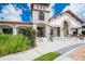 Clubhouse exterior with stone tower, arched entrance, and professional landscaping at 9330 Meadow Hunt Way, Winter Garden, FL 34787