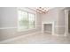 Bright dining room with a decorative fireplace, stylish chandelier, and large window with blinds at 9330 Meadow Hunt Way, Winter Garden, FL 34787