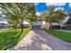 Charming two-story home boasts a brick driveway, two-car garage, and well-manicured lawn at 9330 Meadow Hunt Way, Winter Garden, FL 34787