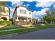 Inviting two-story home featuring a well-maintained lawn and beautifully landscaped surroundings at 9330 Meadow Hunt Way, Winter Garden, FL 34787