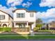 Charming two-story home with a manicured front yard and a welcoming front porch at 9330 Meadow Hunt Way, Winter Garden, FL 34787