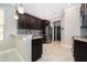 Modern kitchen featuring dark cabinets, granite countertops, stainless steel appliances, and tile backsplash at 9330 Meadow Hunt Way, Winter Garden, FL 34787