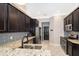 Beautiful kitchen featuring dark cabinets, granite countertops, stainless steel appliances and tiled backsplash at 9330 Meadow Hunt Way, Winter Garden, FL 34787