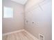 Clean laundry room with white walls, wooden floor, and wire shelving ready for appliances at 9330 Meadow Hunt Way, Winter Garden, FL 34787