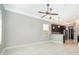Bright and spacious living room boasts tile floors and leads into an open kitchen with dark cabinets at 9330 Meadow Hunt Way, Winter Garden, FL 34787