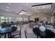 Upscale lounge area with modern seating, elegant chandeliers, and large windows offering natural light at 9330 Meadow Hunt Way, Winter Garden, FL 34787