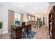 Office space boasts dark wood floors, a large desk, a blue accent rug, and stairway views at 9330 Meadow Hunt Way, Winter Garden, FL 34787