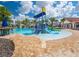 Fun splash pad area with colorful water features and a large pool, surrounded by palm trees at 9330 Meadow Hunt Way, Winter Garden, FL 34787