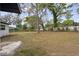 Large backyard featuring mature trees and a well-maintained fence, offering privacy at 239 S Lake Cortez Dr, Apopka, FL 32703