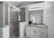 Bathroom with a shower, vanity sink and glass door to backyard at 239 S Lake Cortez Dr, Apopka, FL 32703