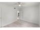 Spacious bedroom with light wood floors, ceiling fan, and an open doorway at 239 S Lake Cortez Dr, Apopka, FL 32703