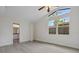 Bright bedroom with vaulted ceilings and large windows, showing bathroom, provides natural light at 239 S Lake Cortez Dr, Apopka, FL 32703