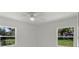 Bright bedroom featuring natural light from two windows and a modern ceiling fan at 239 S Lake Cortez Dr, Apopka, FL 32703