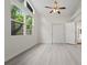 Bright bedroom with vaulted ceilings and large windows provides ample natural light at 239 S Lake Cortez Dr, Apopka, FL 32703