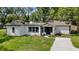 Charming white home featuring a well-manicured lawn and contrasting black trim accents at 239 S Lake Cortez Dr, Apopka, FL 32703