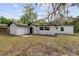 Rear exterior of the home, showcasing the architectural details and backyard access at 239 S Lake Cortez Dr, Apopka, FL 32703