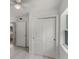 Bright hallway featuring a ceiling fan and a closet with sliding doors for storage at 239 S Lake Cortez Dr, Apopka, FL 32703