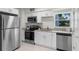 Updated kitchen with stainless steel appliances, granite counters, and bright white cabinets at 239 S Lake Cortez Dr, Apopka, FL 32703