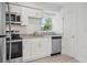 Bright kitchen with white cabinets, stainless appliances, and granite countertops offers a clean, modern design at 239 S Lake Cortez Dr, Apopka, FL 32703