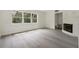 Bright living room featuring a large window with a view, white walls and new flooring at 239 S Lake Cortez Dr, Apopka, FL 32703