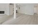 Open concept living area features new floors and white brick fireplace with views into the kitchen at 239 S Lake Cortez Dr, Apopka, FL 32703