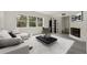 Bright living room showcasing sleek furniture, a large window view, and a cozy fireplace, all bathed in natural light at 239 S Lake Cortez Dr, Apopka, FL 32703