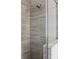 This renovated shower features stylish gray marble-look tile, a modern shower head, and sleek glass doors at 239 S Lake Cortez Dr, Apopka, FL 32703