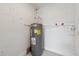 A view of the home's hot water heater and connections in a utility room or basement area at 239 S Lake Cortez Dr, Apopka, FL 32703