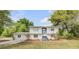 Charming two-story home with manicured lawn, blue trim, and inviting staircase leading to the front entrance at 2550 Barren Oak Ct, Deland, FL 32720