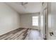 Cozy bedroom featuring gray vinyl floors, a ceiling fan, and a window with blinds at 294 San Gabriel St, Winter Springs, FL 32708