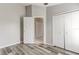 Well-lit bedroom showcasing gray vinyl flooring, closets, and access to an adjacent room at 294 San Gabriel St, Winter Springs, FL 32708