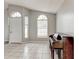Open living room with neutral walls, large windows, tiled floors, and a piano against the wall at 294 San Gabriel St, Winter Springs, FL 32708