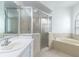 Bathroom showcasing a glass enclosed shower and large tub, creating a clean, functional space at 321 Moffat Loop, Oviedo, FL 32765