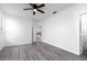 Bright bedroom with wood-look flooring and ceiling fan, offering a fresh, contemporary feel at 321 Moffat Loop, Oviedo, FL 32765