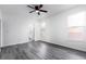 Sunlit bedroom with sleek wood-look floors, white walls, and window, providing a blank canvas for customization at 321 Moffat Loop, Oviedo, FL 32765