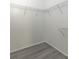 Walk-in closet featuring wire shelving and wood-look floors, providing efficient storage solutions at 321 Moffat Loop, Oviedo, FL 32765