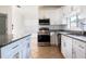 Modern kitchen featuring granite countertops, stainless steel appliances, and a kitchen island at 321 Moffat Loop, Oviedo, FL 32765