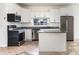 Modern kitchen featuring white cabinets, granite countertops, and stainless steel appliances at 321 Moffat Loop, Oviedo, FL 32765