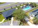 Aerial view of community pool, clubhouse, and walking paths surrounded by lush landscaping at 3296 Tranquil Trl, Kissimmee, FL 34747