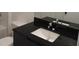 Contemporary bathroom features white sink, black countertop and toilet at 3296 Tranquil Trl, Kissimmee, FL 34747