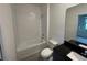 Bathroom with a full tub, toilet, sleek mirror and a modern sink at 3296 Tranquil Trl, Kissimmee, FL 34747