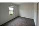 Cozy bedroom with neutral walls, carpeted floors, and ample natural light from window at 3296 Tranquil Trl, Kissimmee, FL 34747