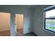 Cozy bedroom featuring a window, carpet floors and walk-in closet at 3296 Tranquil Trl, Kissimmee, FL 34747